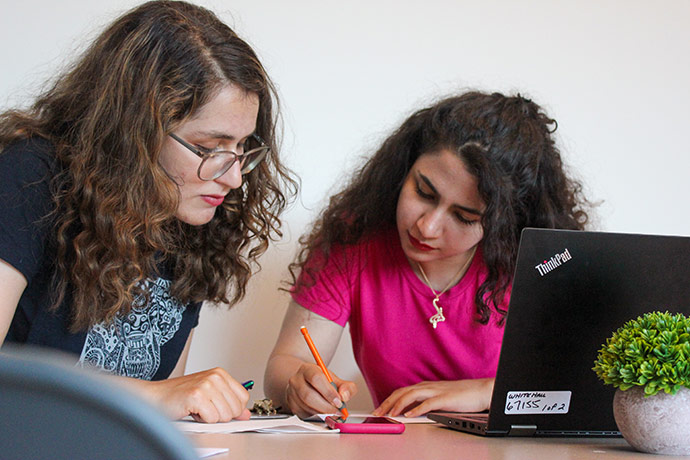 two female students with laptop open