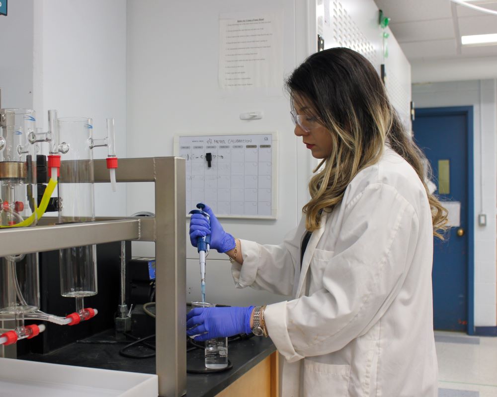 A scientist piping liquid into a beaker